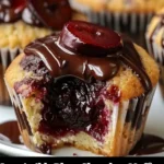 Freshly baked plum chocolate muffins on a wooden table