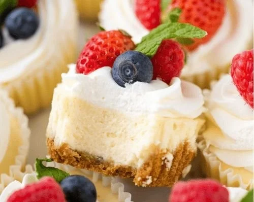 Delicious mini cheesecakes topped with fresh fruit and whipped cream
