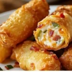 Mini jalapeno popper egg rolls on a plate, crispy and delicious appetizer