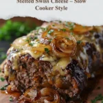 Slow cooker French onion meatloaf topped with melted Swiss cheese