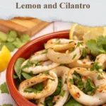 Plate of grilled calamari garnished with lemon and cilantro