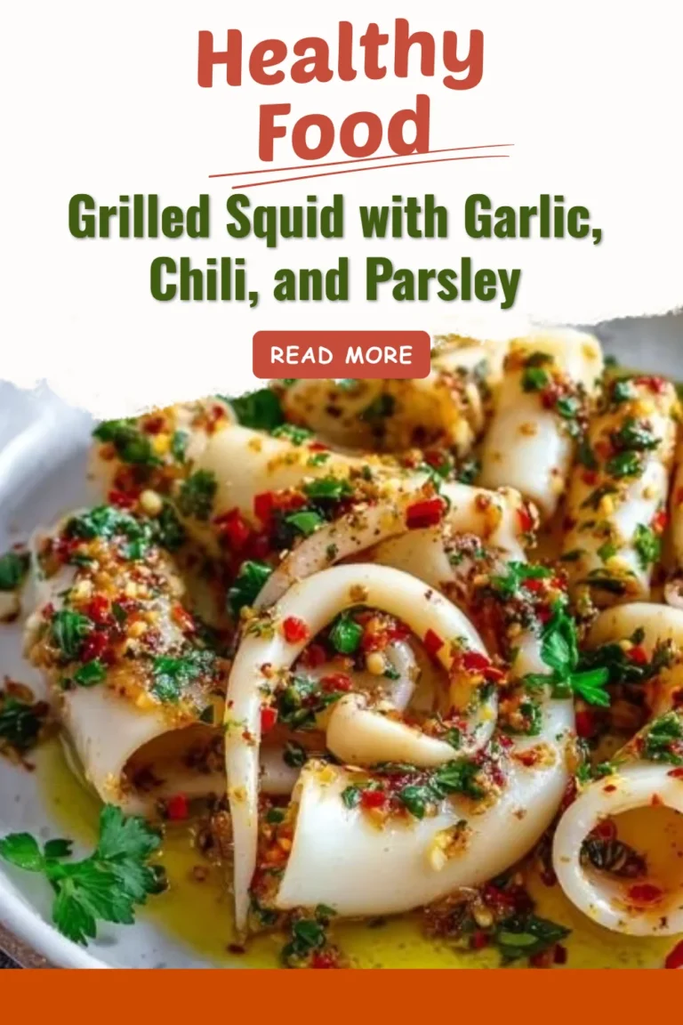 Grilled squid garnished with garlic, chili, and parsley on a white plate.