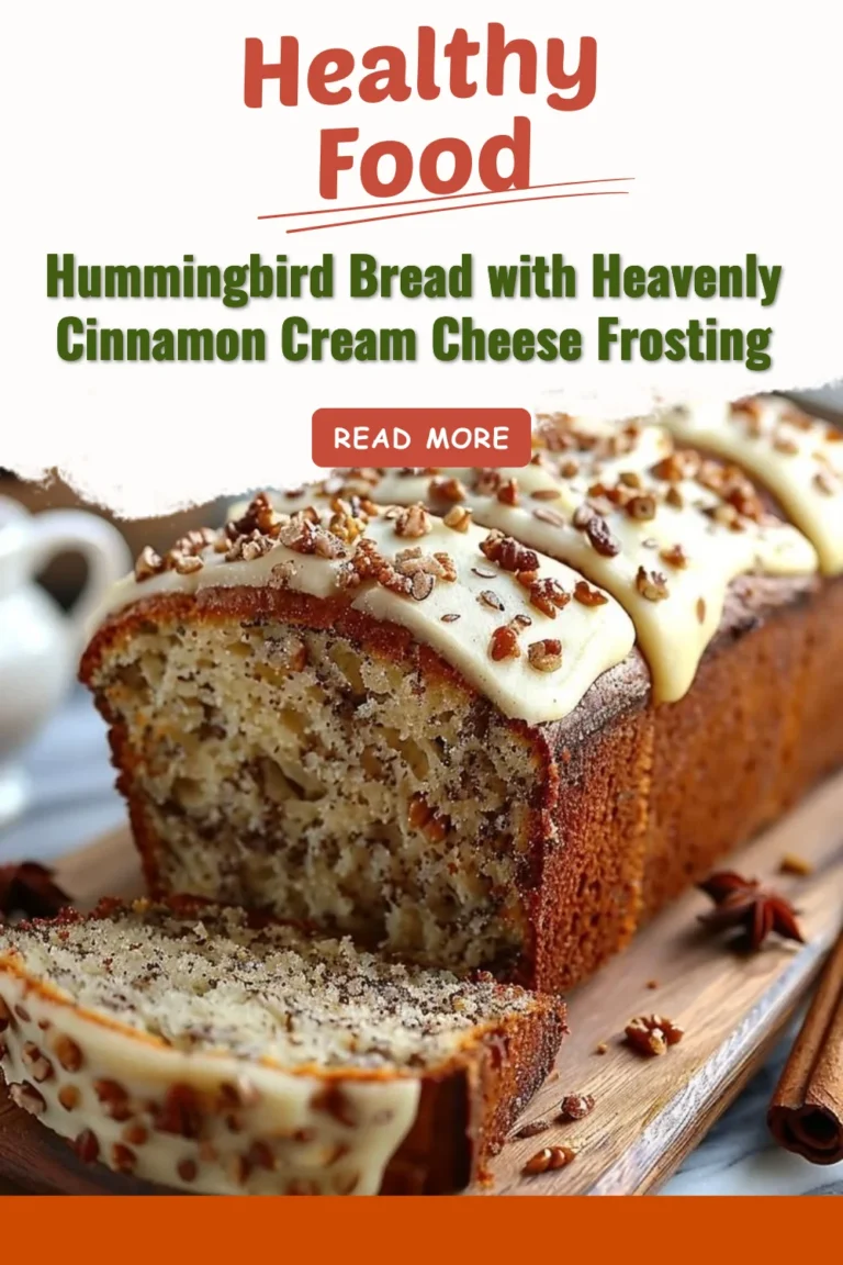 Hummingbird Bread topped with cinnamon cream cheese frosting on a wooden table