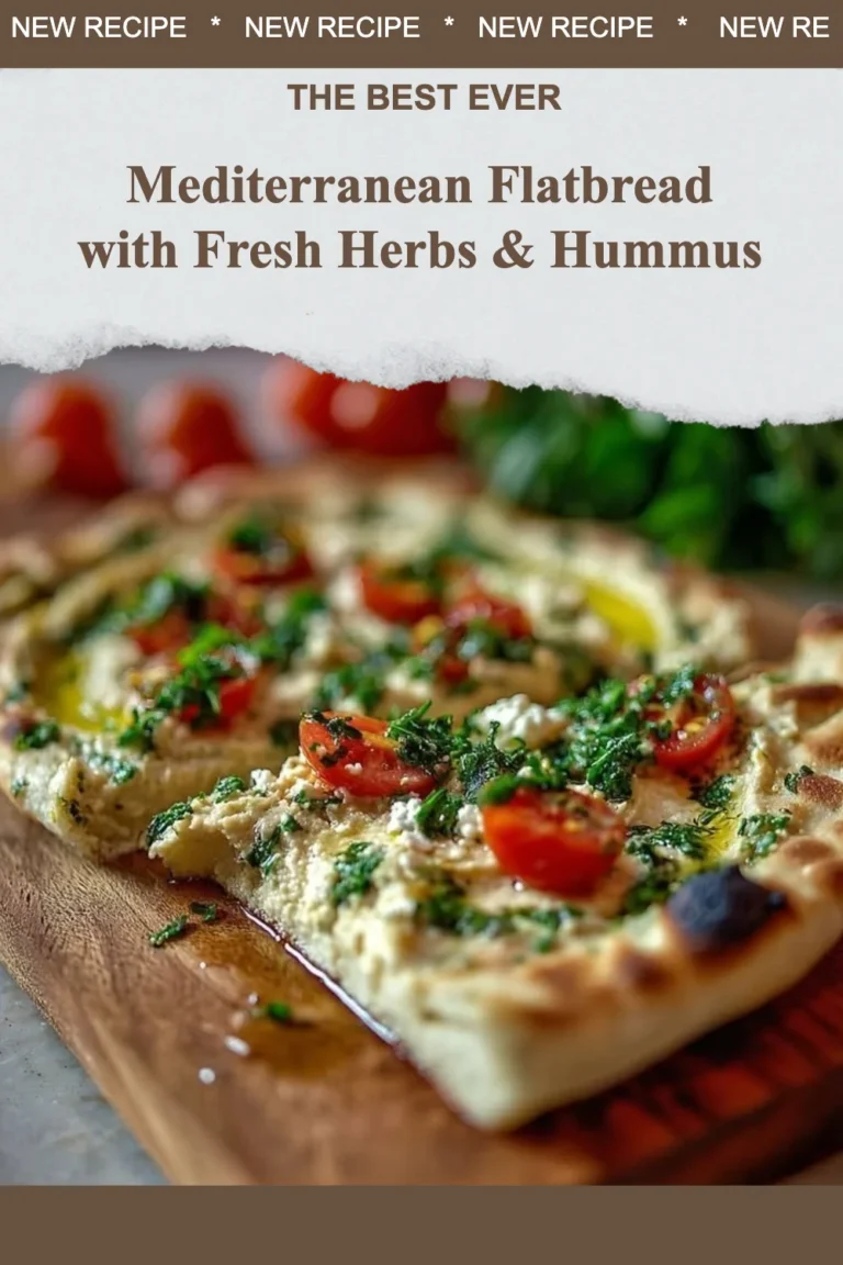 Mediterranean flatbread topped with fresh herbs and hummus on a wooden board