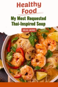 Bowl of Thai soup with fresh herbs, spices, and vibrant ingredients