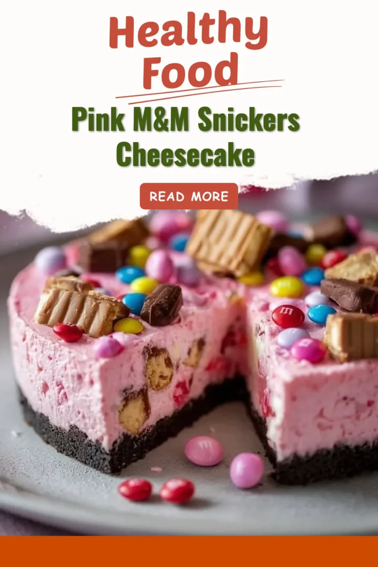 A slice of Pink M&M Snickers Cheesecake topped with colorful candies