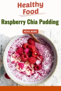 Bowl of raspberry chia pudding topped with fresh raspberries and mint leaves