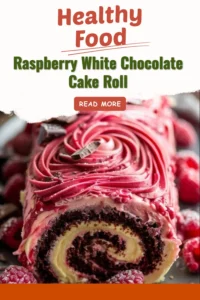 Raspberry White Chocolate Cake Roll beautifully presented on a plate with fresh raspberries