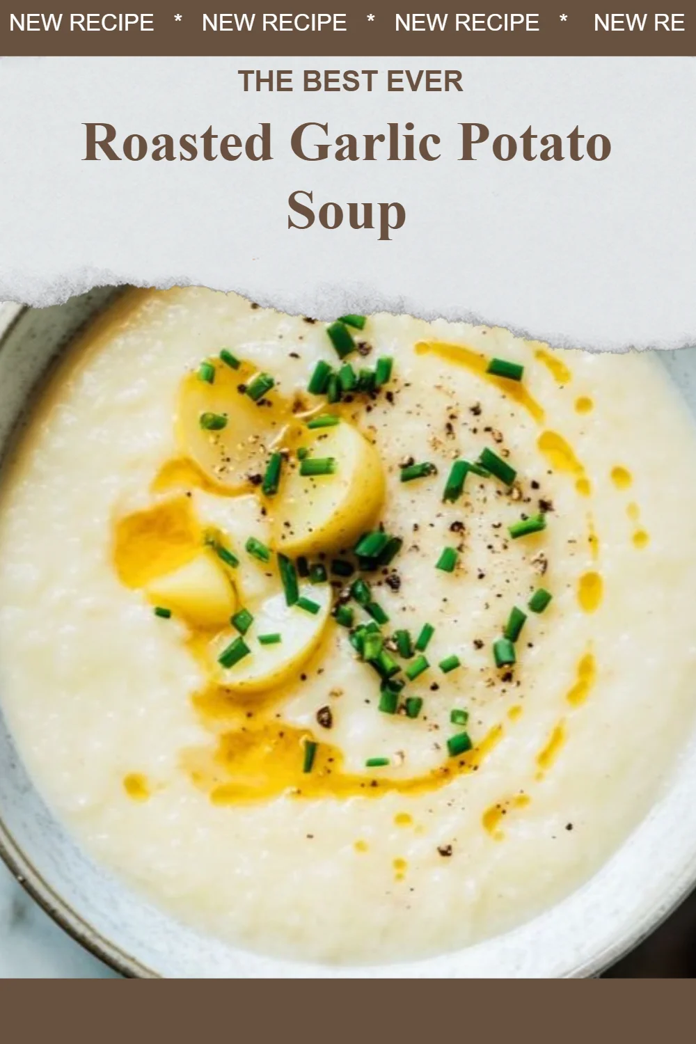 Bowl of creamy roasted garlic potato soup garnished with herbs