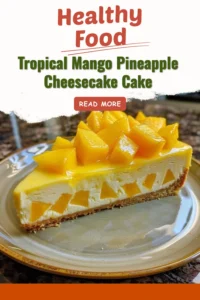 Tropical mango pineapple cheesecake cake topped with fresh fruits and a creamy layer.