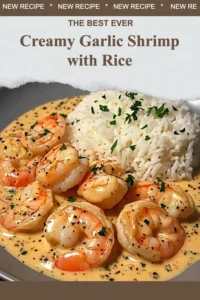 Plate of creamy garlic shrimp served with rice on a wooden table.