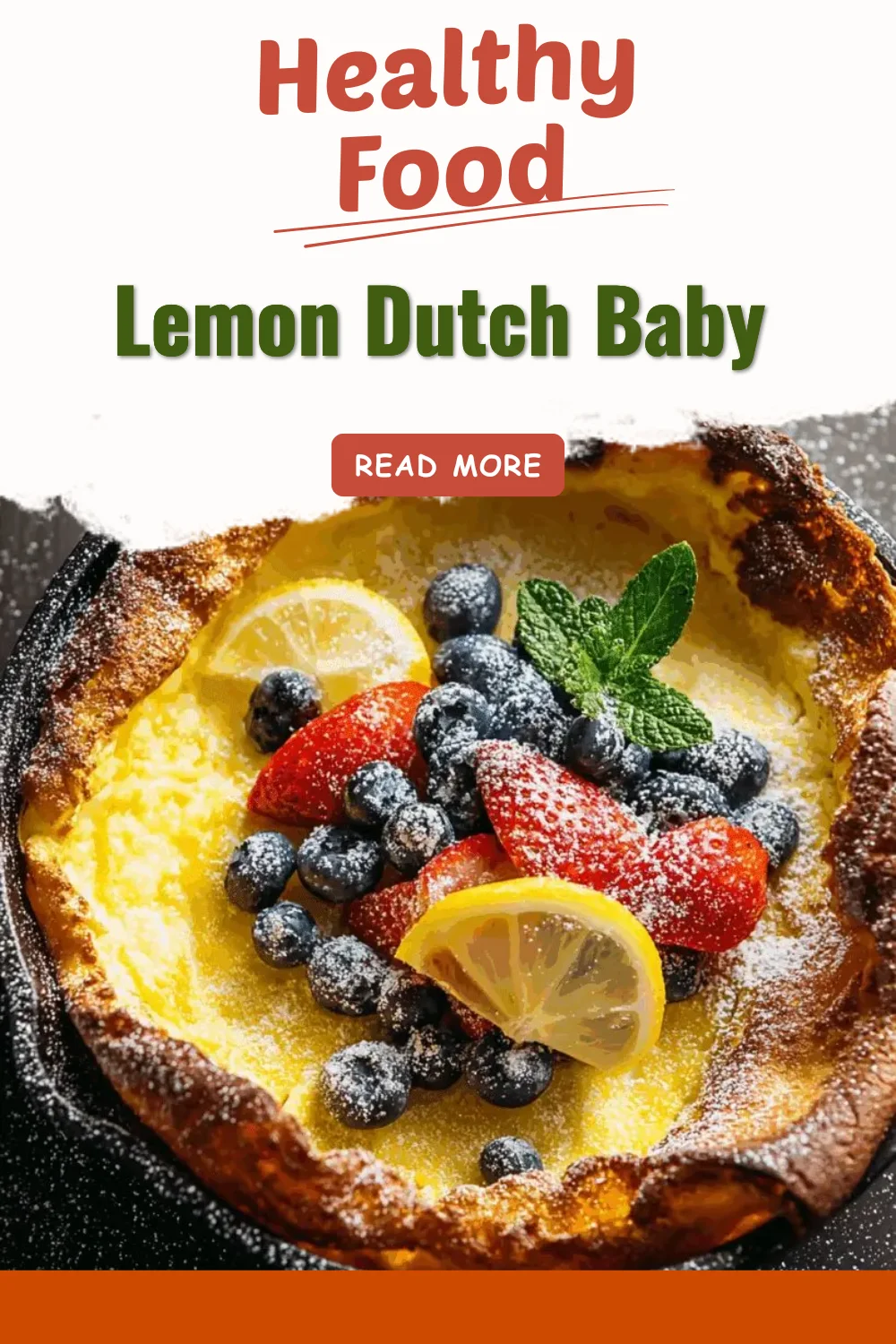 Fluffy Lemon Dutch Baby pancake topped with lemon slices and powdered sugar.