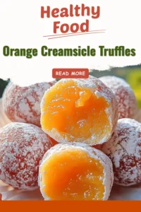 Delicious orange creamsicle truffles on a rustic wooden table