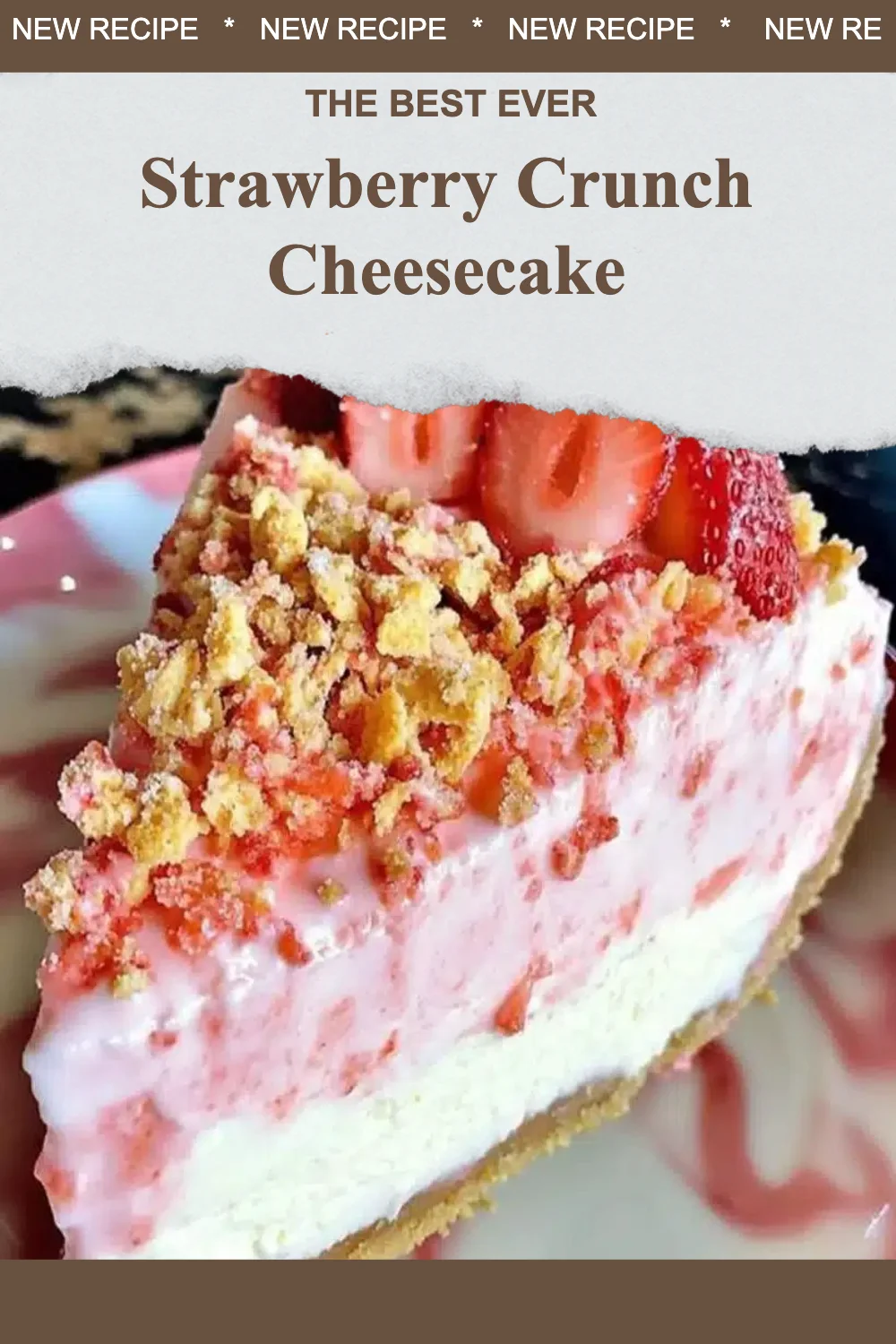 Slice of strawberry crunch cheesecake topped with strawberry and crumbs