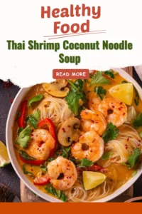 Bowl of Thai shrimp coconut noodle soup with shrimp and fresh herbs.