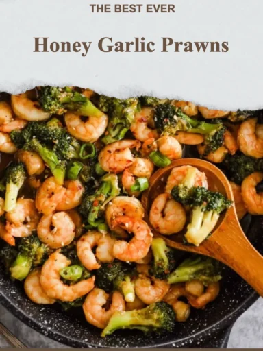 Plate of honey garlic prawns garnished with herbs, showcasing a delicious seafood dish.