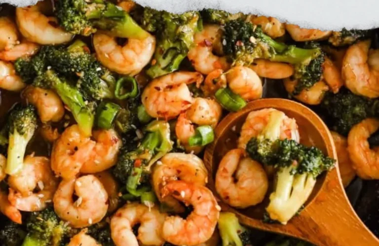 Plate of honey garlic prawns garnished with herbs, showcasing a delicious seafood dish.