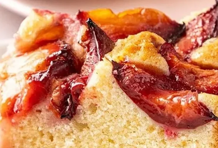Delicious slice of homemade plum cake served on a rustic plate