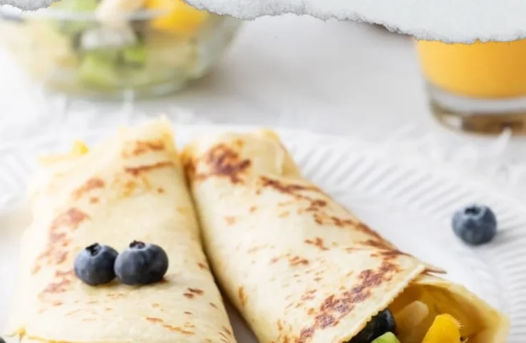 Tropical fruit crepes filled with fresh fruits and served on a plate