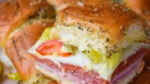 Delicious hot Italian sub sliders with meats and cheeses on a platter
